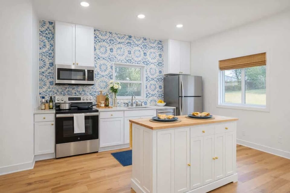 Mediterranean-inspired kitchen with modern appliances, custom cabinetry, and a spacious central island. Bright and inviting, with plenty of room to cook, gather, and enjoy slow breakfasts or relaxed dinners together at Teeni Santorini.
