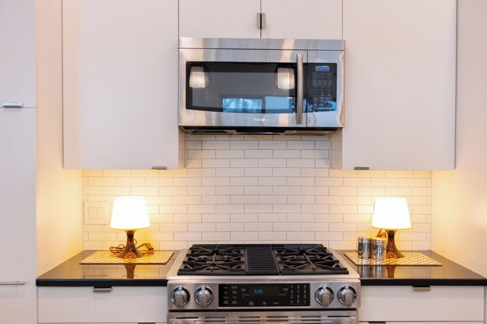 Your modern kitchen features a sleek stainless steel range and microwave, perfect for preparing meals during your stay.