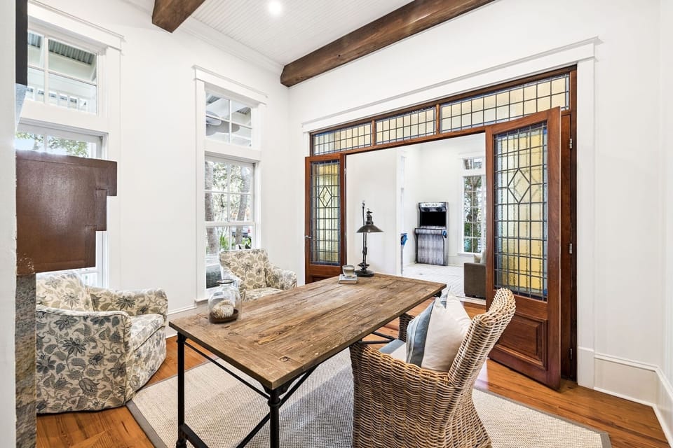 Your bright workspace features rustic beams, stained glass doors, and garden views for inspiring productivity.