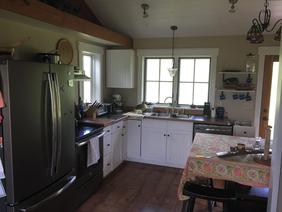 Natural light floods the full size kitchen with premium appliances