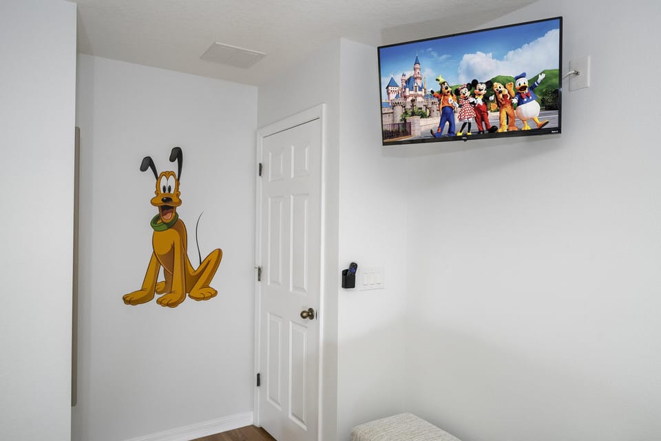 Second floor Cozy bedroom corner with playful wall art and TV viewing