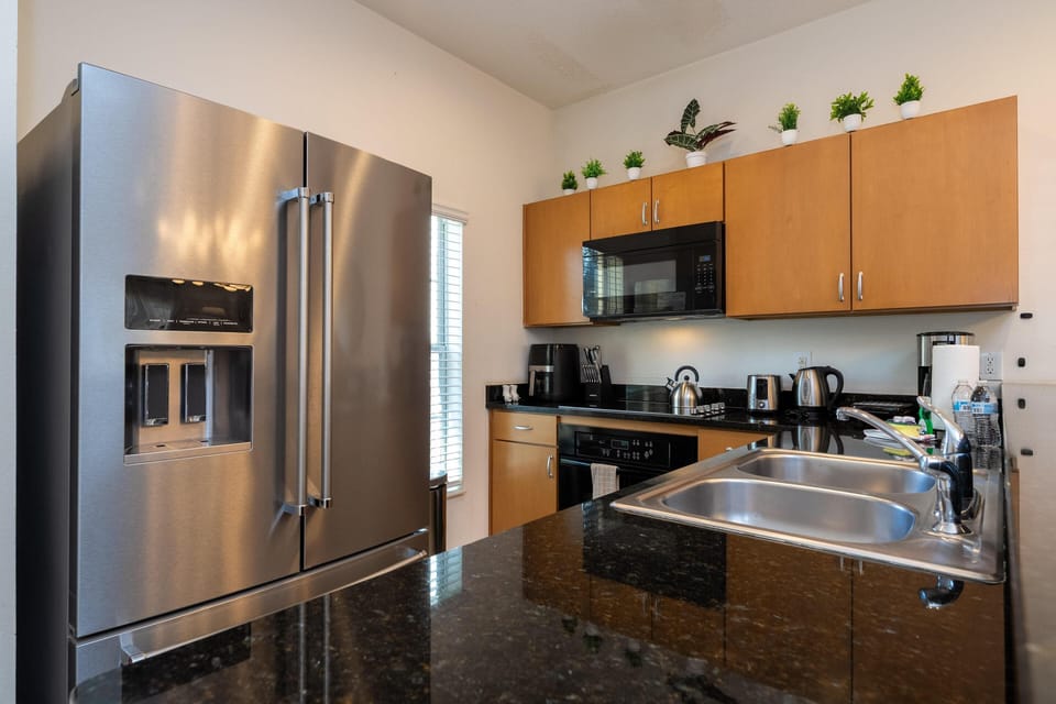 Modern kitchen with sleek appliances and granite countertops