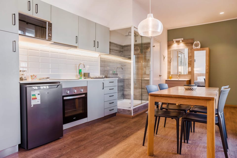 Experience modern living with a sleek kitchen and dining area, perfect for cozy meals.