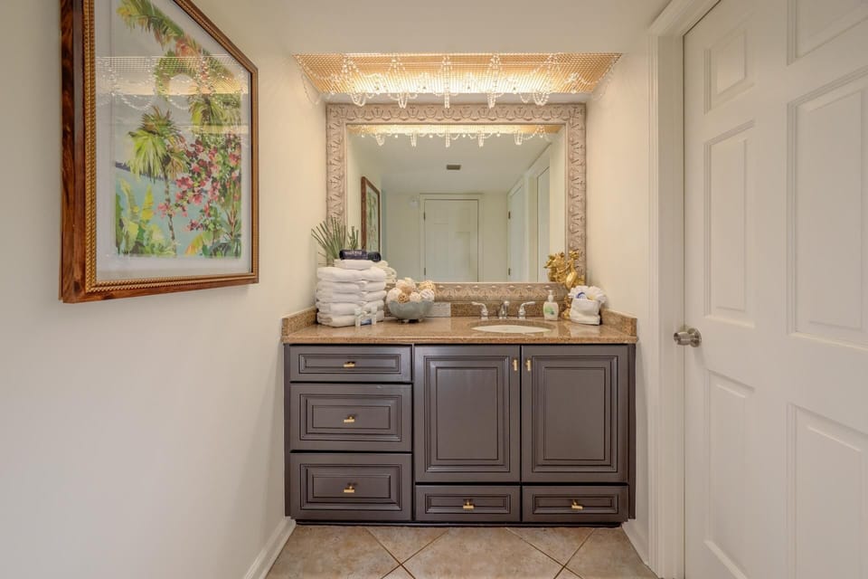 Bright and spacious bathroom with elegant vanity and large mirror