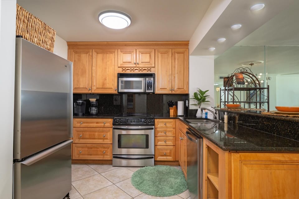 Modern kitchen with stainless steel appliances and warm wood cabinetry