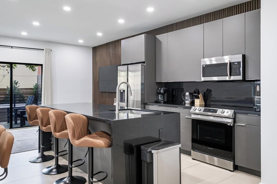 Modern kitchen with a large island and comfortable seating for casual dining.