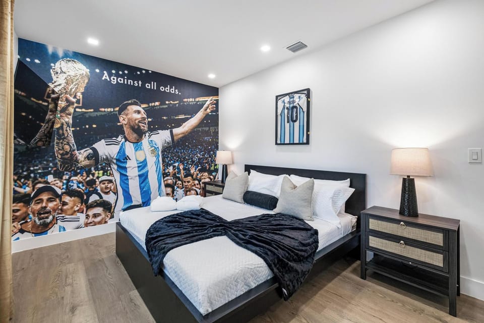 bedroom with a sports-themed mural and framed jersey creating a unique atmosphere