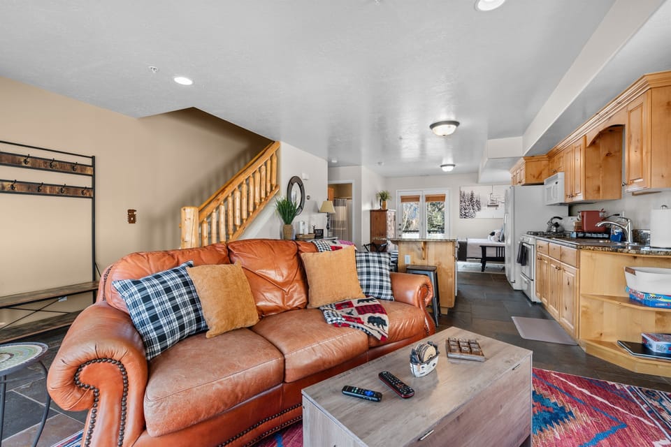 Open-concept living features a sleeper sofa.