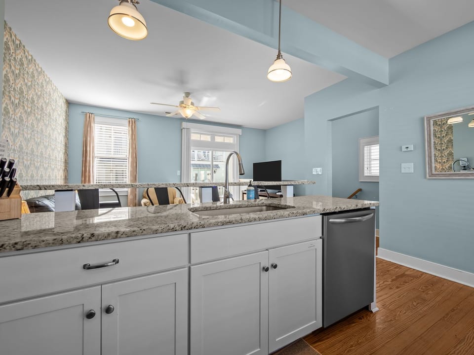 Granite island and modern appliances flow seamlessly into the living area