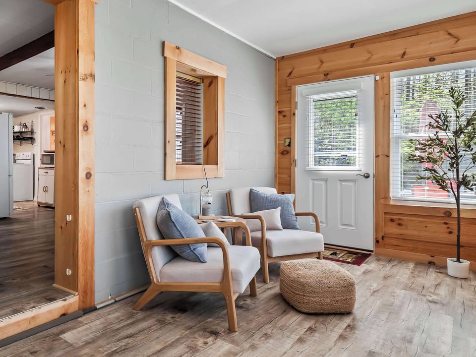 Warm wood-paneled game room w/ comfy seating, ideal for laid-back hangouts