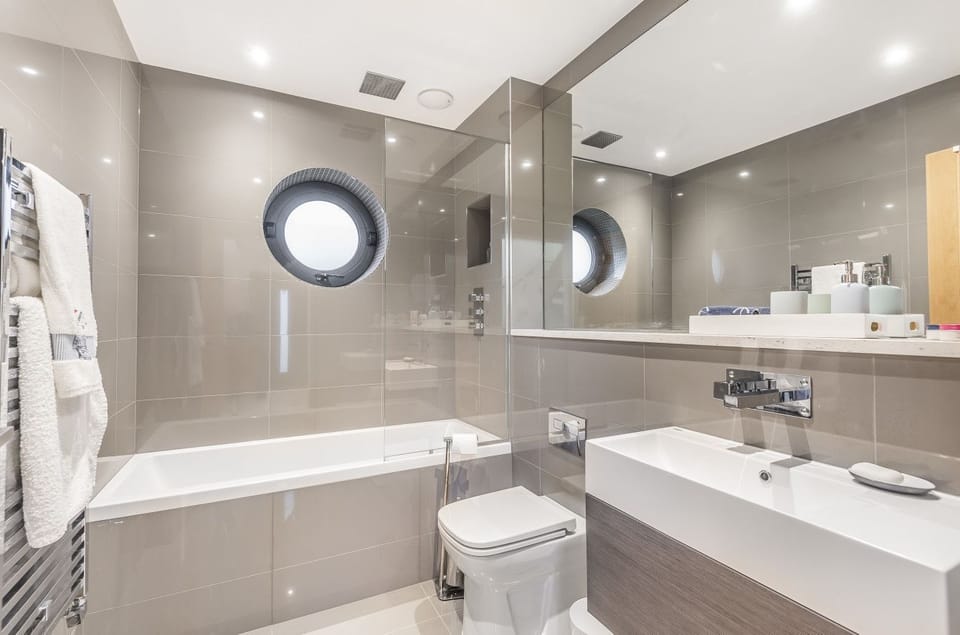 Family ground floor bathroom with shower over bath