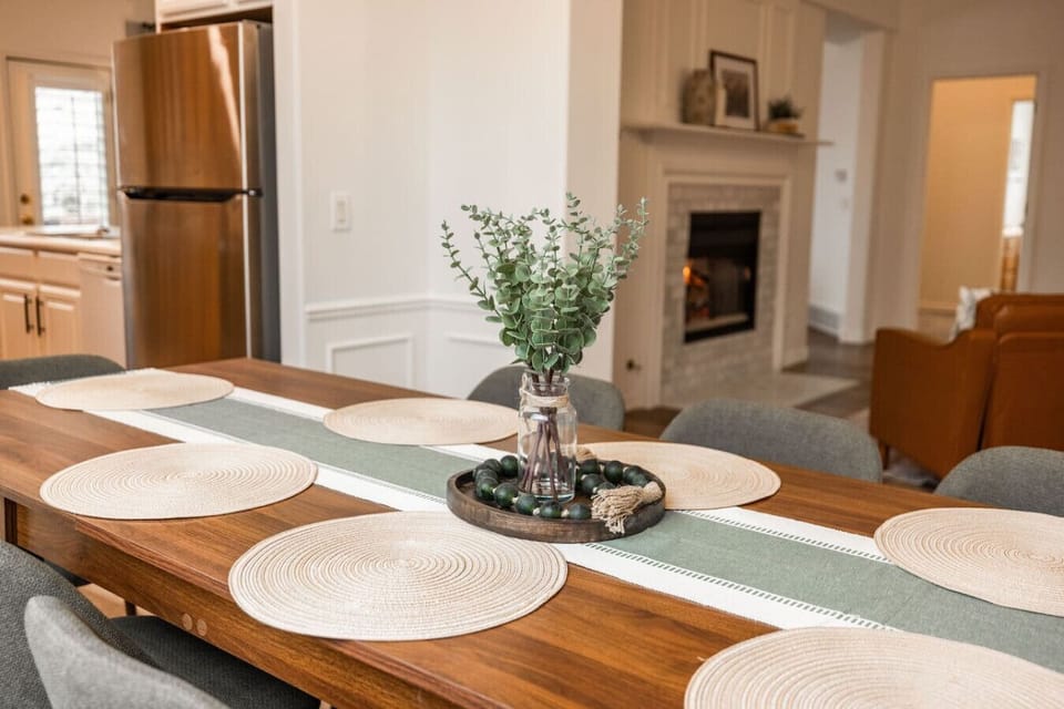 Dining table set for meals, located near kitchen and living area.
