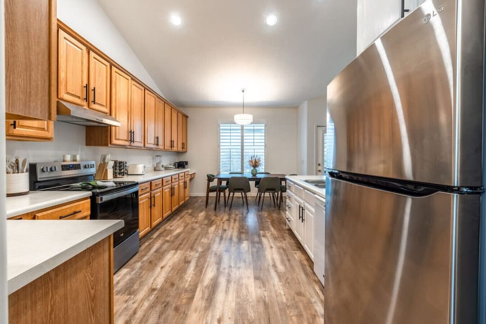 Fully equipped kitchen with stainless steel appliances, ample counter space, and dining nook.