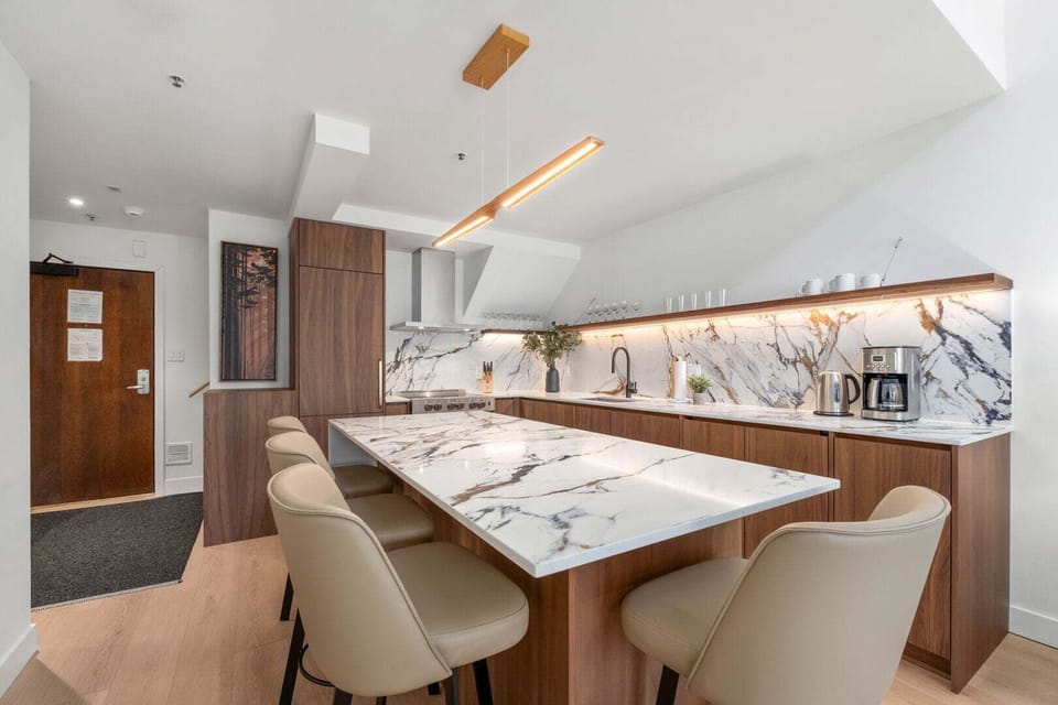 Modern kitchen equipped with modern appliances and island counter top.