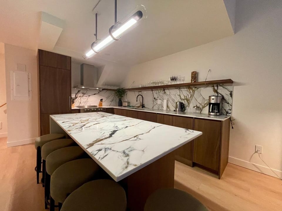Modern kitchen equipped with modern appliances and island counter top.
