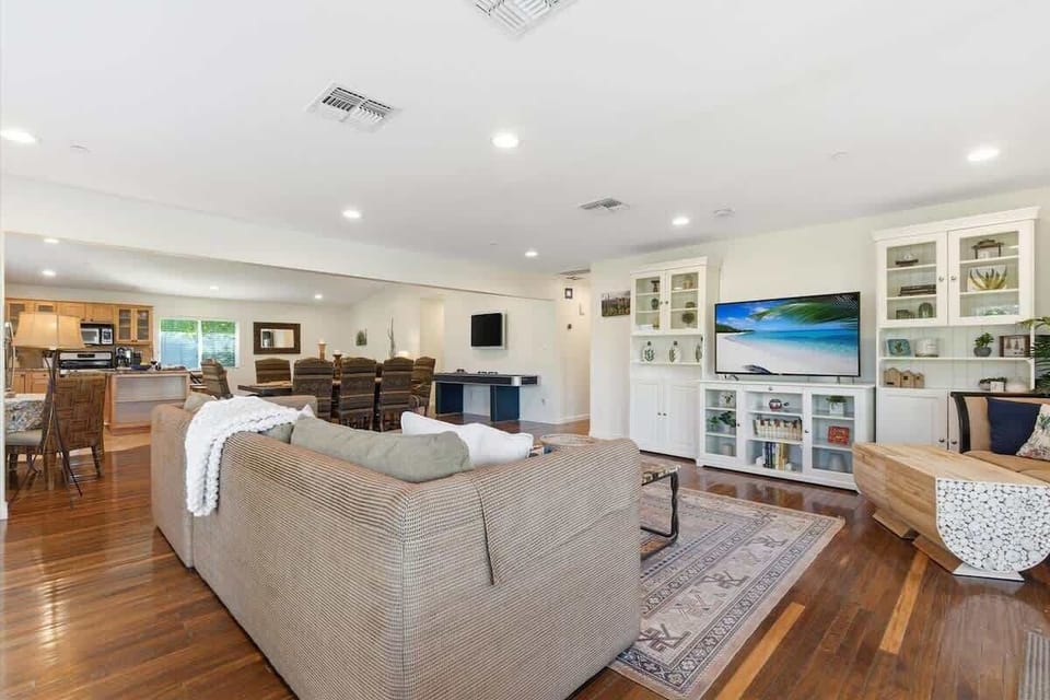 Main living area featuring cozy furnishings, a Smart TV, workstation with a office desk and chair, and access to the backyard.