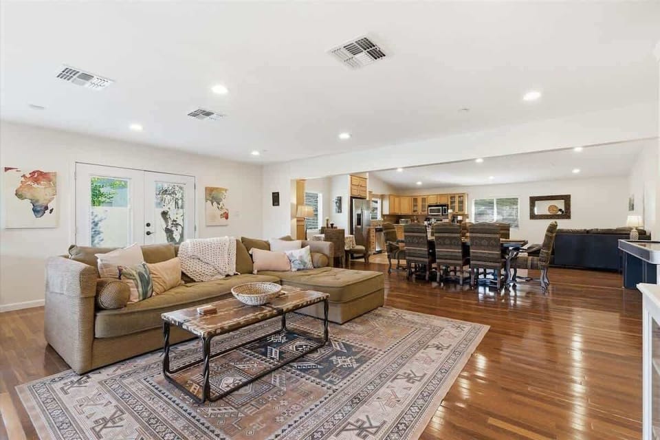 Main living area featuring cozy furnishings, a Smart TV, workstation with a office desk and chair, and access to the backyard.