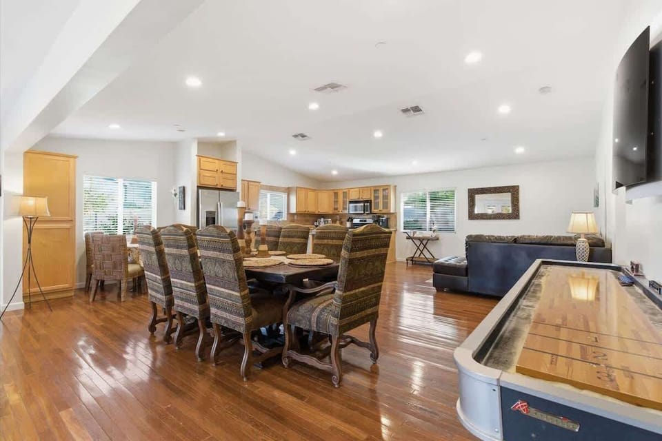 Formal dining area with seating for 8, informal dining area with seating for 4 guests, and a shuffleboard.