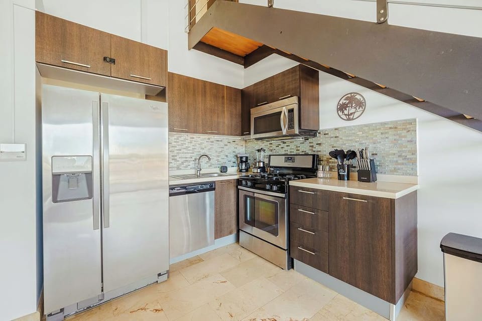 Cook with ease in this fully equipped, modern kitchen featuring stainless steel appliances and everything you need for meals at home during your stay.