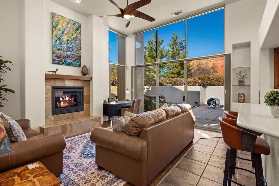 Welcoming great room, tasteful southwestern design with windows displaying views and pouring in natural light