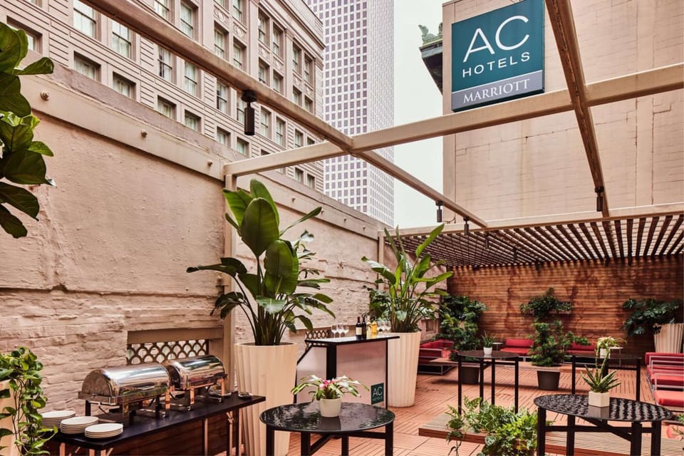 Outdoor patio with plants, seating, and buffet tables