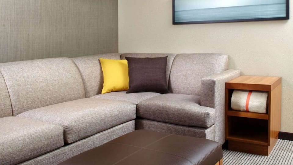 Sofa with accent pillows and side table storage.