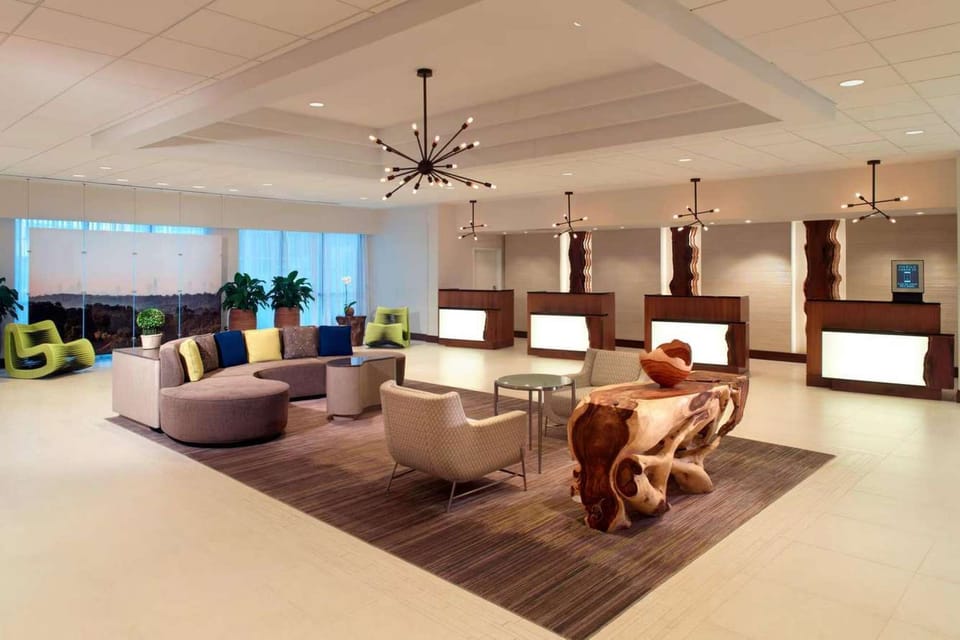 Spacious lobby with couches, chairs, and bright ceiling lights