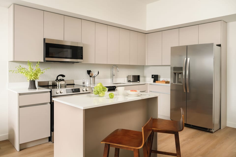 The culinary heart features high-end stainless steel appliances and quartz countertops.