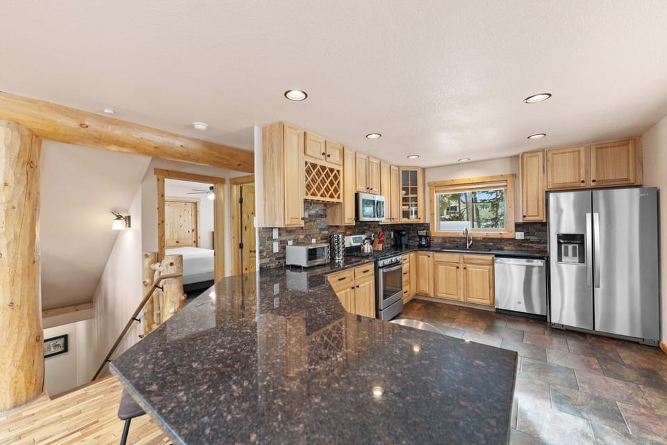 Whip up memorable meals in your fully-equipped gourmet kitchen featuring granite countertops, stainless steel appliances, and rustic wood accents.