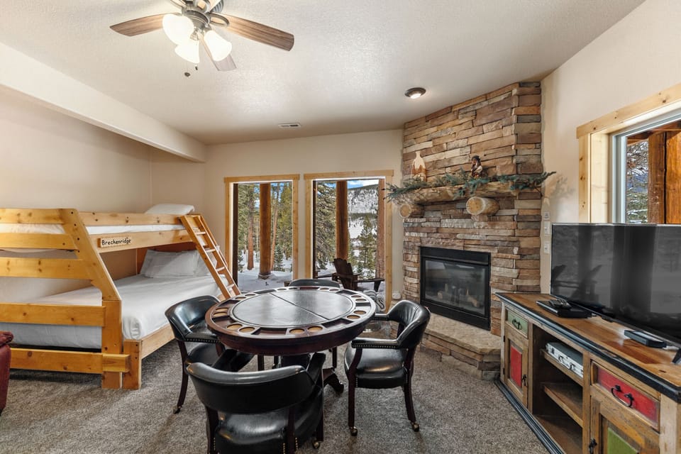 Gather around the game table or cozy up by your stone fireplace in this inviting space with mountain views.