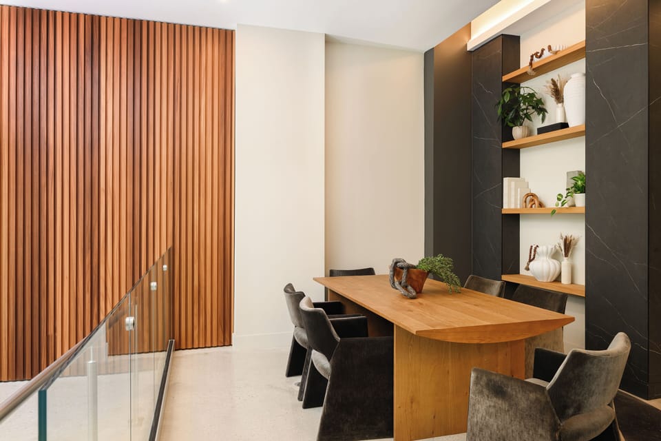 Elegant wood-slat feature walls create a sophisticated dining backdrop.