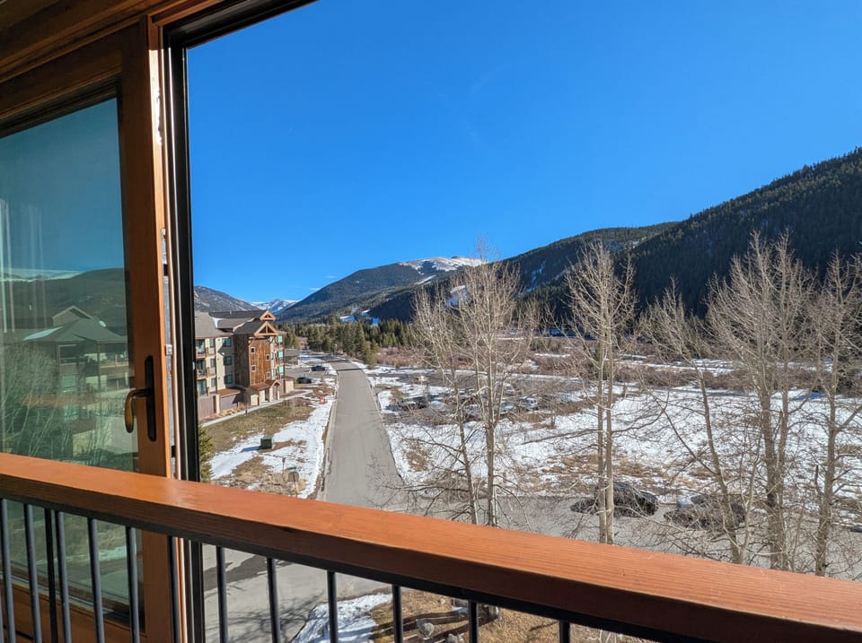 Mountain views from large sliding windows - showcase snow-capped peaks