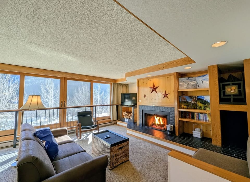 Such an inviting living area with views, fireplace and multiple seating areas