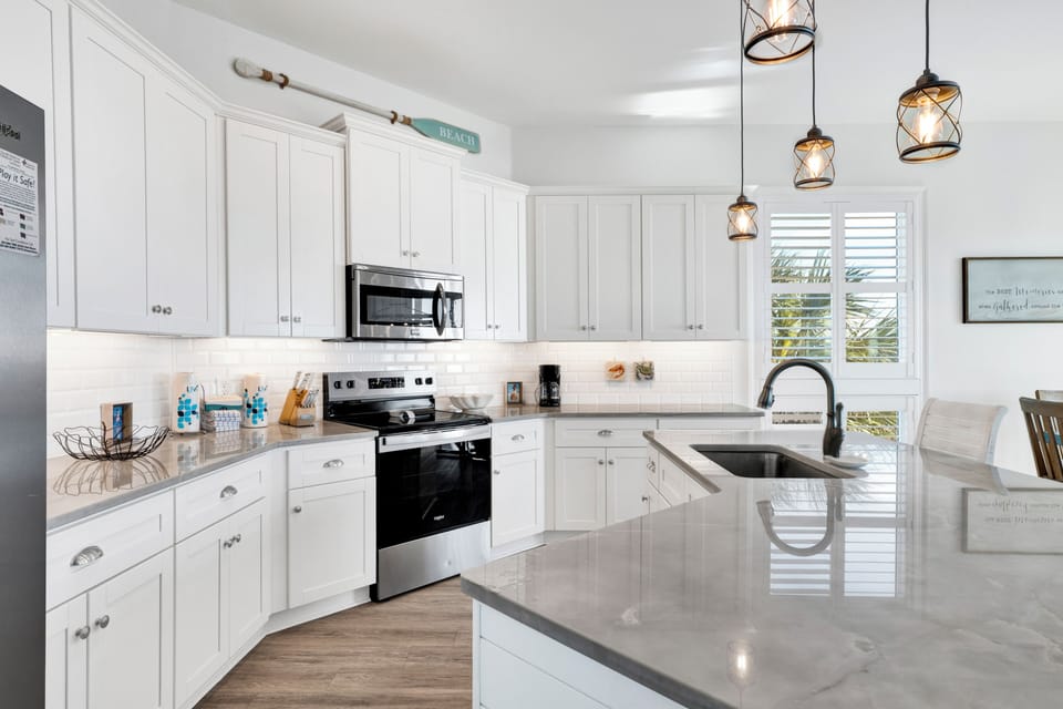 Your spacious kitchen sparkles with bright white cabinets and gleaming countertops, perfect for creating memorable meals together.