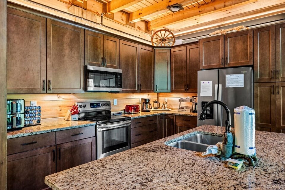 Gather around the oversized island while meals are prepared or snacks are shared. The open layout keeps everyone connected throughout your stay.