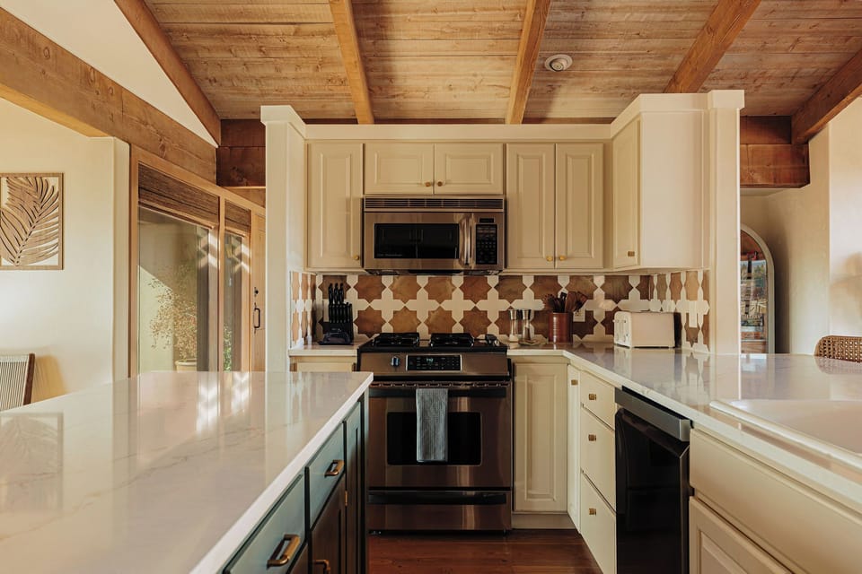 Your gourmet kitchen features exposed beam ceilings, marble countertops, and stainless steel appliances for creating memorable meals.