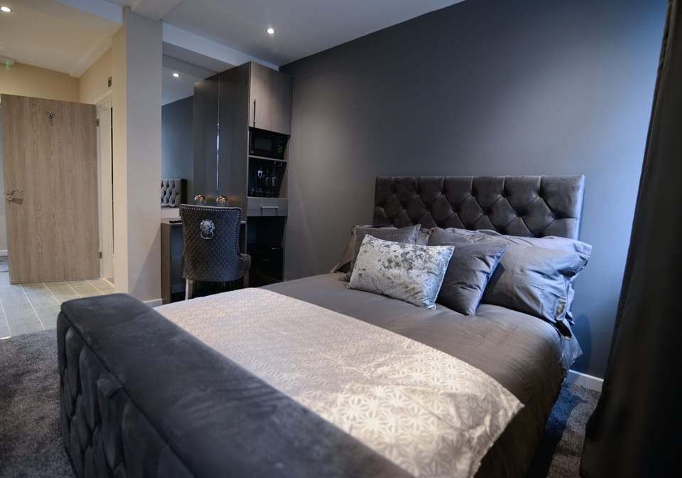 Suite, Private Bathroom | Desk, laptop workspace, blackout drapes, iron/ironing board