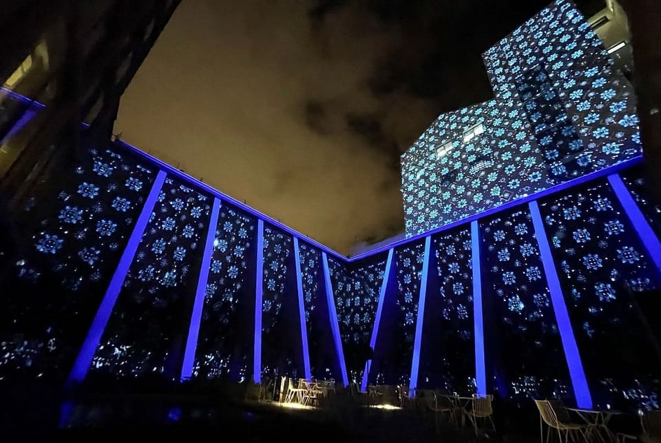 Step outside to a glowing courtyard under dramatic night skies.