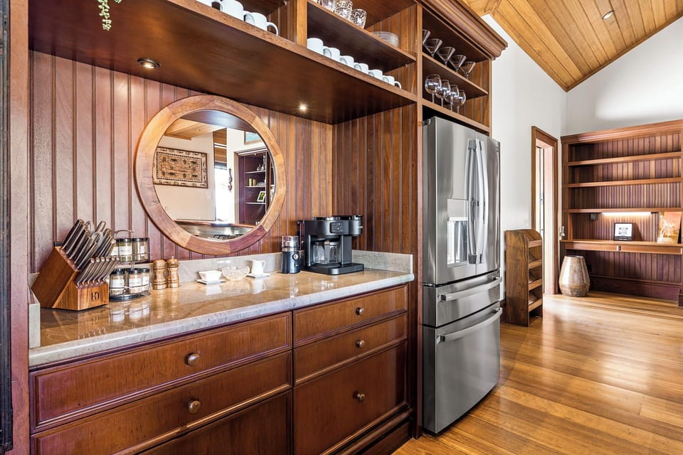 Step into your beautiful kitchen featuring rich wood cabinetry, granite counters, and stainless appliances—perfect for preparing meals in style.