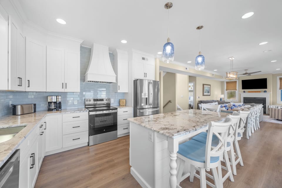 Your gourmet kitchen awaits with gleaming granite countertops, stainless steel appliances, and a spacious island for gathering over morning coffee or evening meals together.
