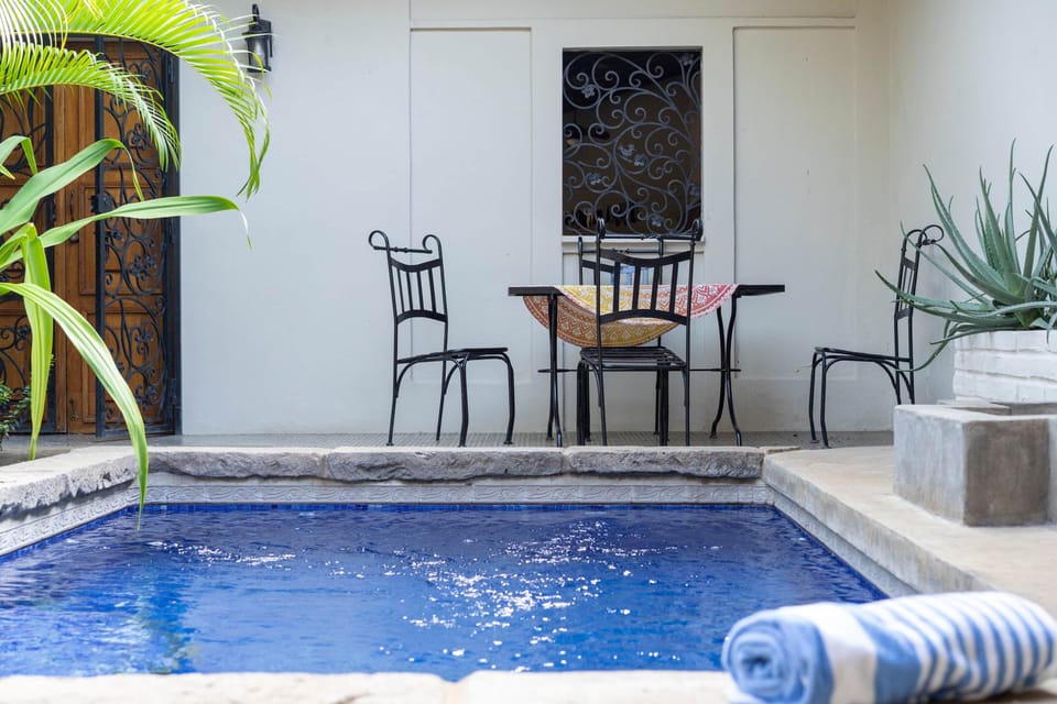 Poolside bistro table by the private pool at a boutique vacation home in Granada, Nicaragua