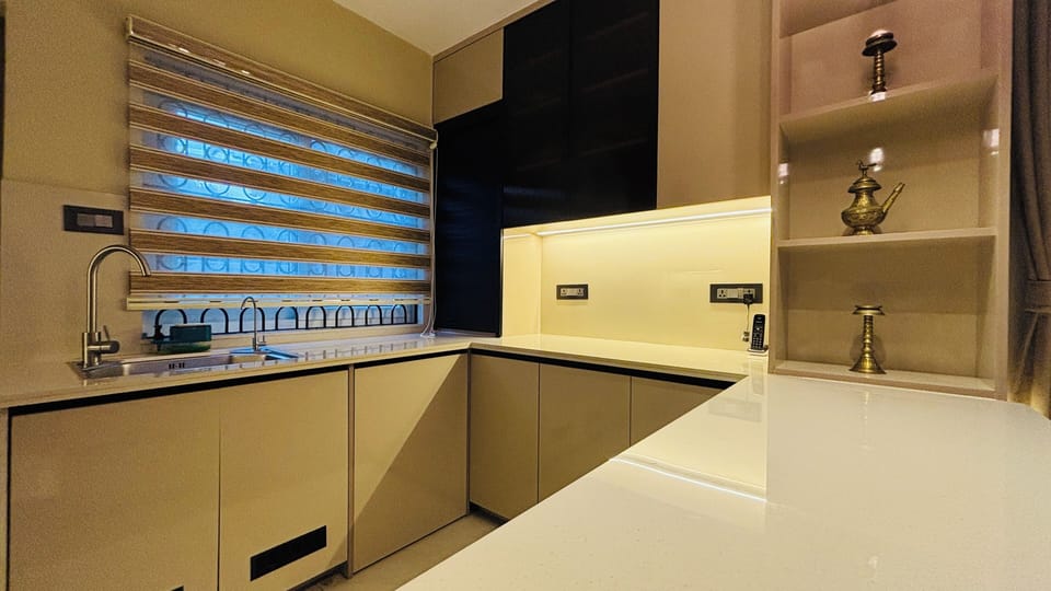 A bright, modern kitchen with a spacious island and sleek sink.