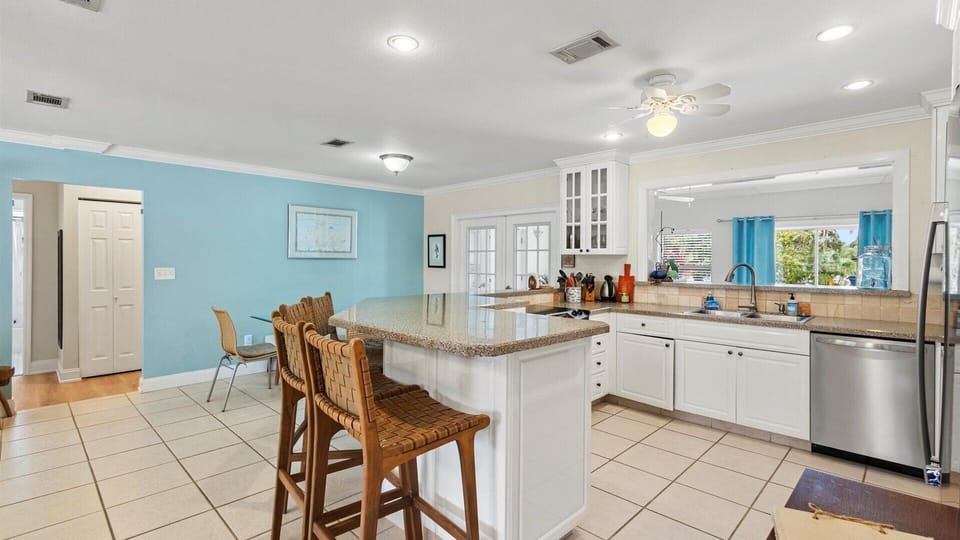 The kitchen shares the open floor plan with the living and dining areas and has a fridge, oven, stove, microwave, dishwasher, coffee maker, toaster, and expresso machine.