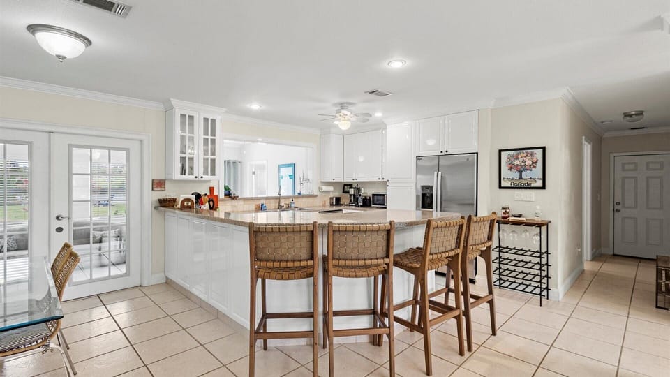 The kitchen has a bar top with seating for four.