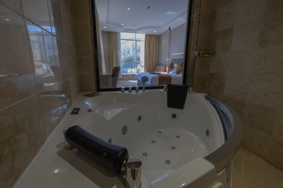 Honeymoon Studio, 1 Bedroom, Hot Tub, City View | Bathroom | Combined shower/tub, hair dryer, slippers, bidet