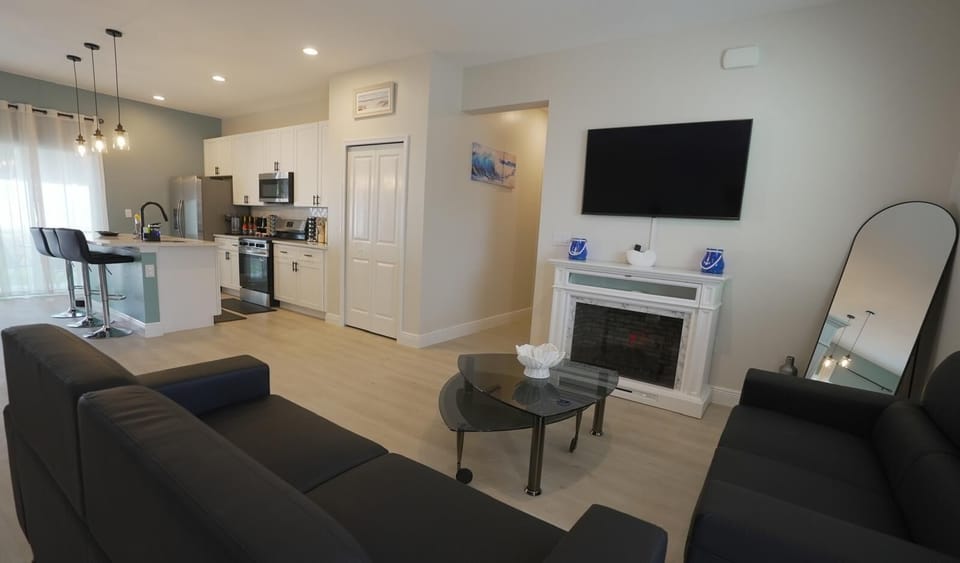 Bright coastal living room with comfy seating, TV, and space to relax