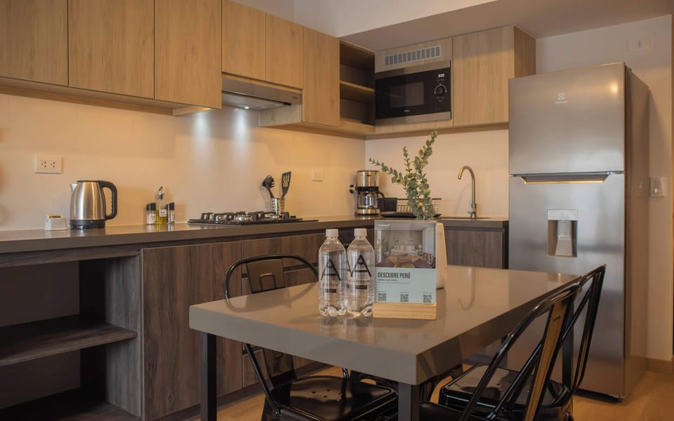 Fully equipped modern kitchen with sleek cabinetry and essential appliances.