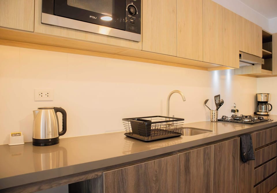 Microwave, kettle, and essential cooking utensils
