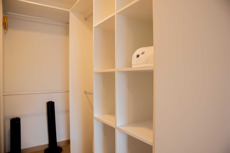 A spacious open closet with shelves and storage areas to keep personal belongings organized