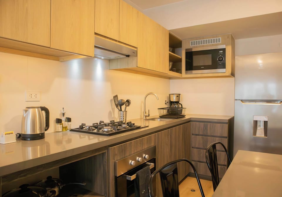 Spacious kitchen with stainless steel countertop and ready-to-use utensils.